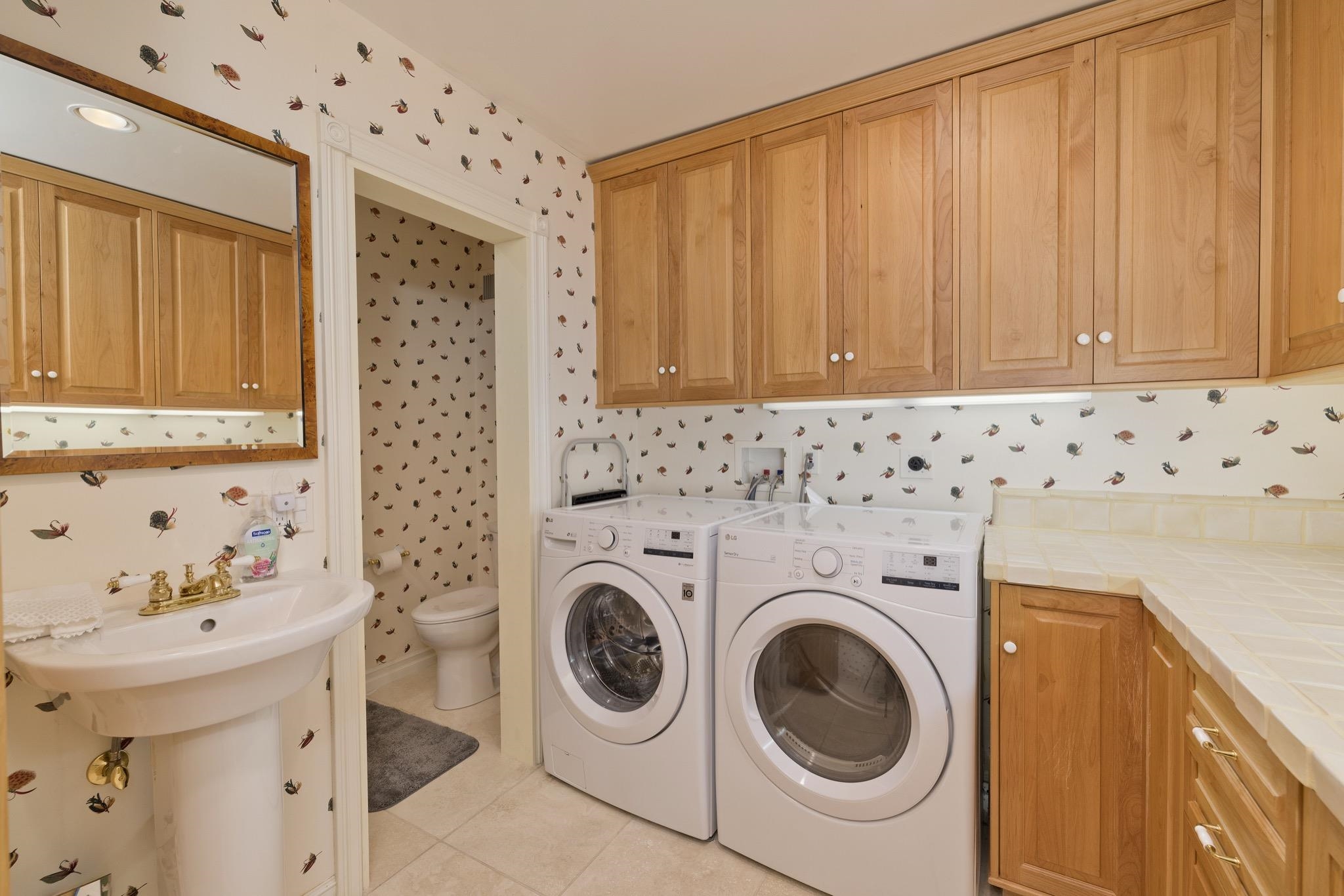 370 Ranch Road Mammoth Lakes, CA 93546 - Photo 24 of 46 Laundry room featuring wallpapered walls, light tile patterned floors, and independent washer and dryer