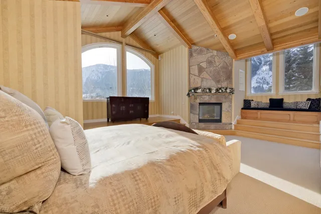 a bedroom with a bed and a fireplace