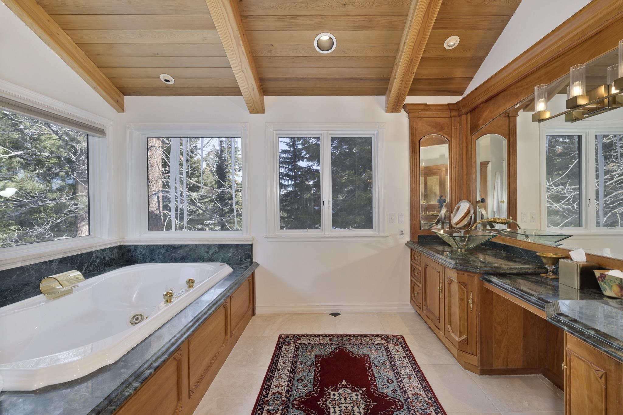 370 Ranch Road Mammoth Lakes, CA 93546 - Photo 28 of 46 Full bathroom with a jetted tub, vanity, wooden ceiling, and light tile patterned floors