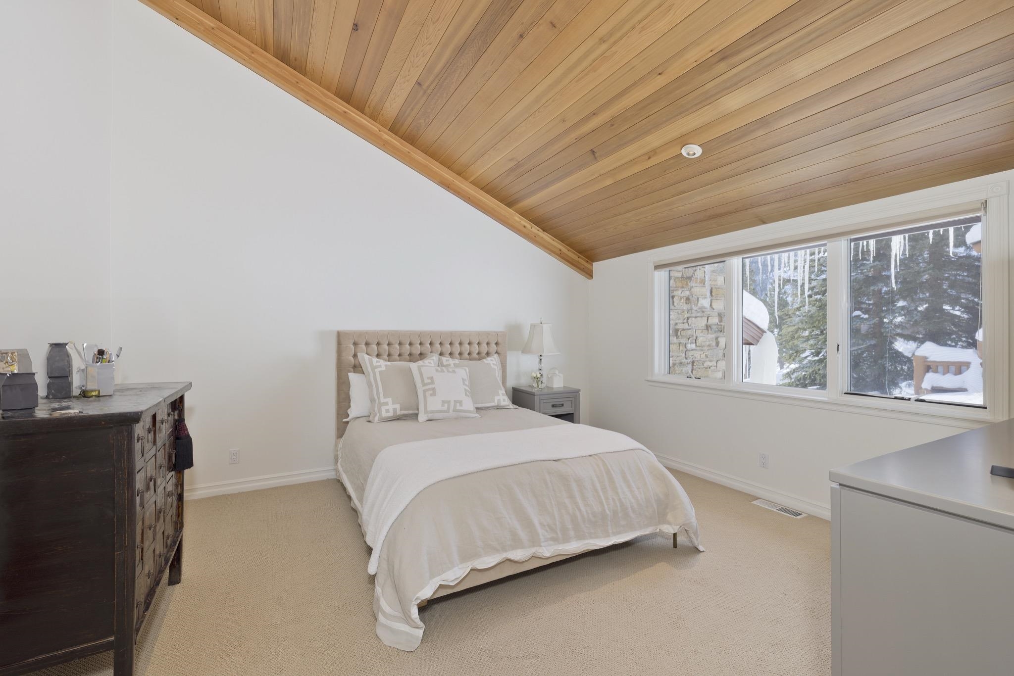 370 Ranch Road Mammoth Lakes, CA 93546 - Photo 31 of 46 Bedroom with vaulted ceiling, wooden ceiling, and light colored carpet