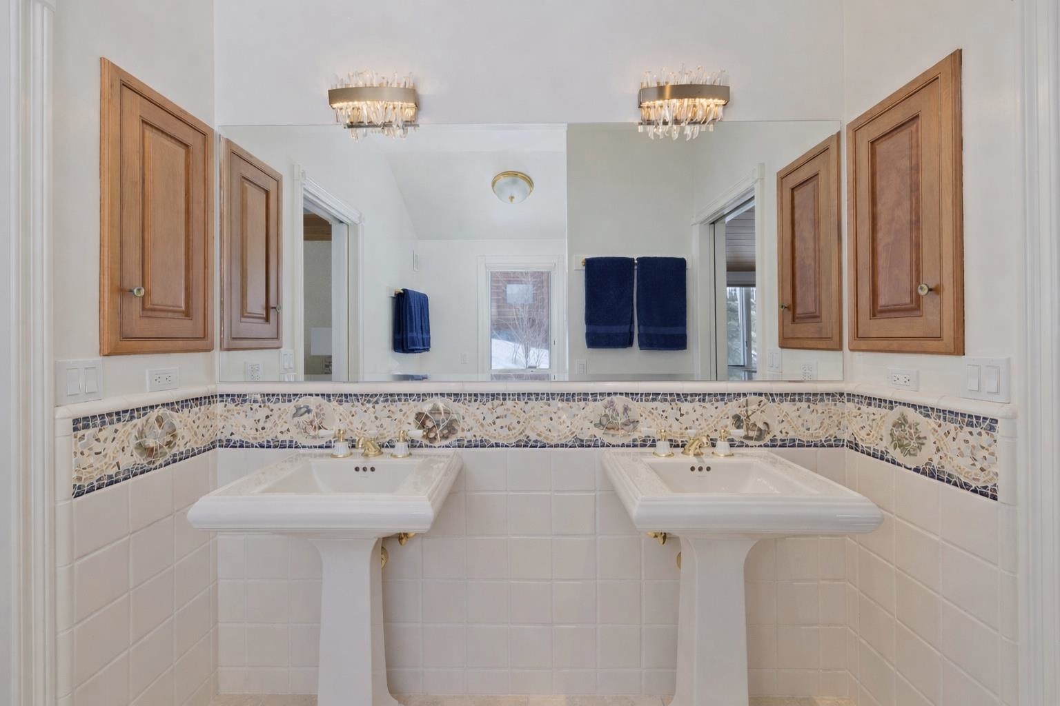 370 Ranch Road Mammoth Lakes, CA 93546 - Photo 33 of 46 Full bathroom with two sinks, tile walls, and wainscoting