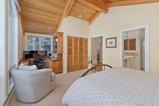 a bedroom with furniture and a large window