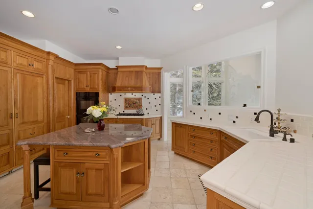 a kitchen with stainless steel appliances granite countertop a sink stove and cabinets
