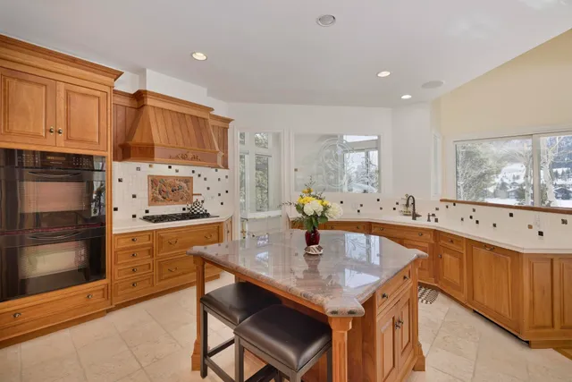 a kitchen with stainless steel appliances granite countertop a stove refrigerator sink and cabinets