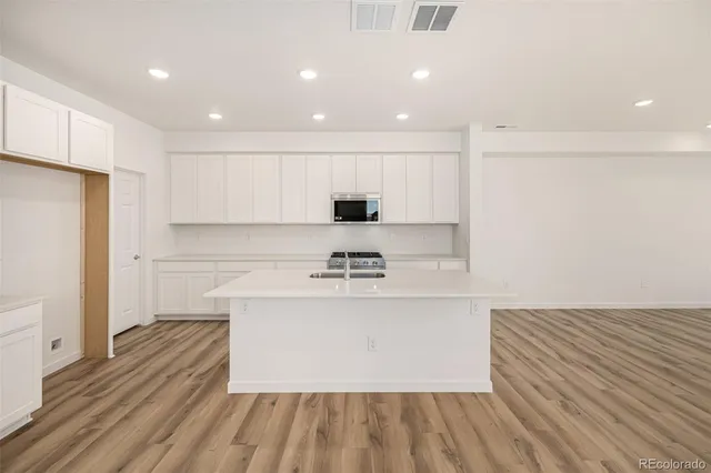a view of a kitchen with a sink and a refrigerator