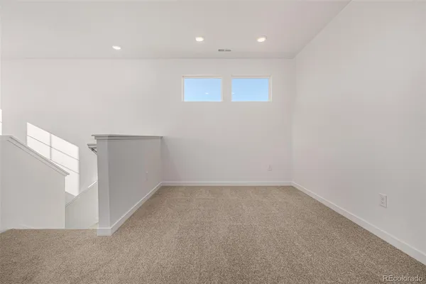 an empty room with windows and pillars in it
