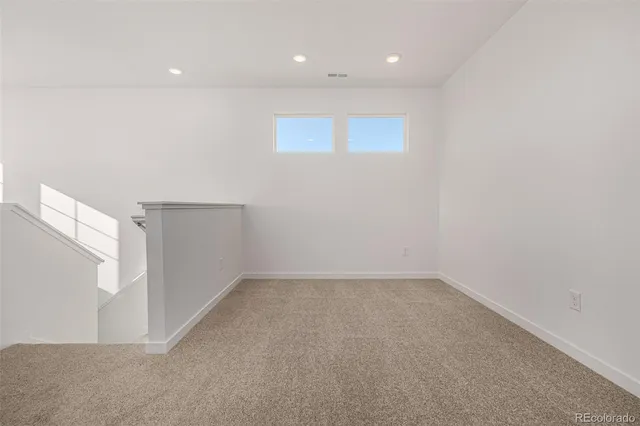 an empty room with windows and pillars in it