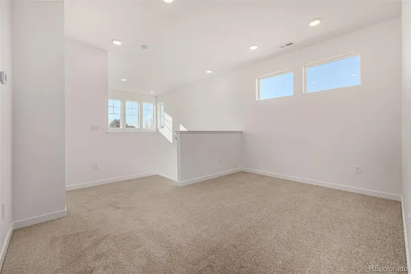 an empty room with windows and closet