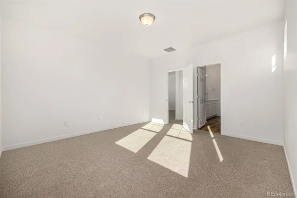 a view of an empty room with windows