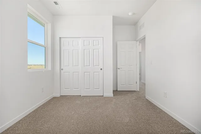 an empty room with closet area