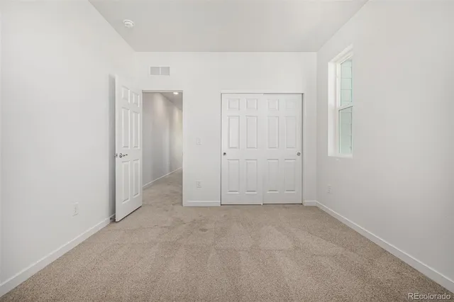 an empty room with closet area