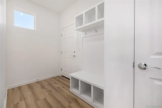 a view of a small space with wooden floor and a window