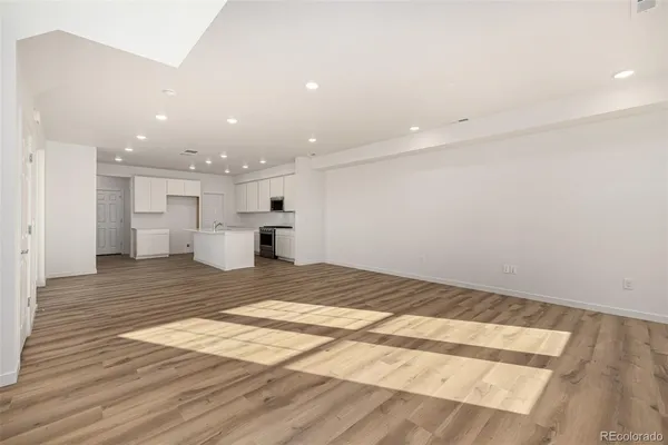 a view of kitchen and empty room