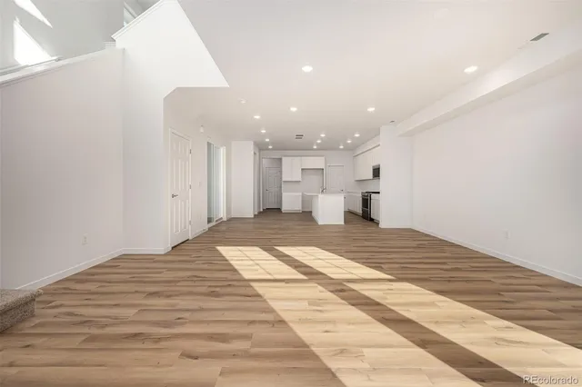 a view of a room with wooden floor