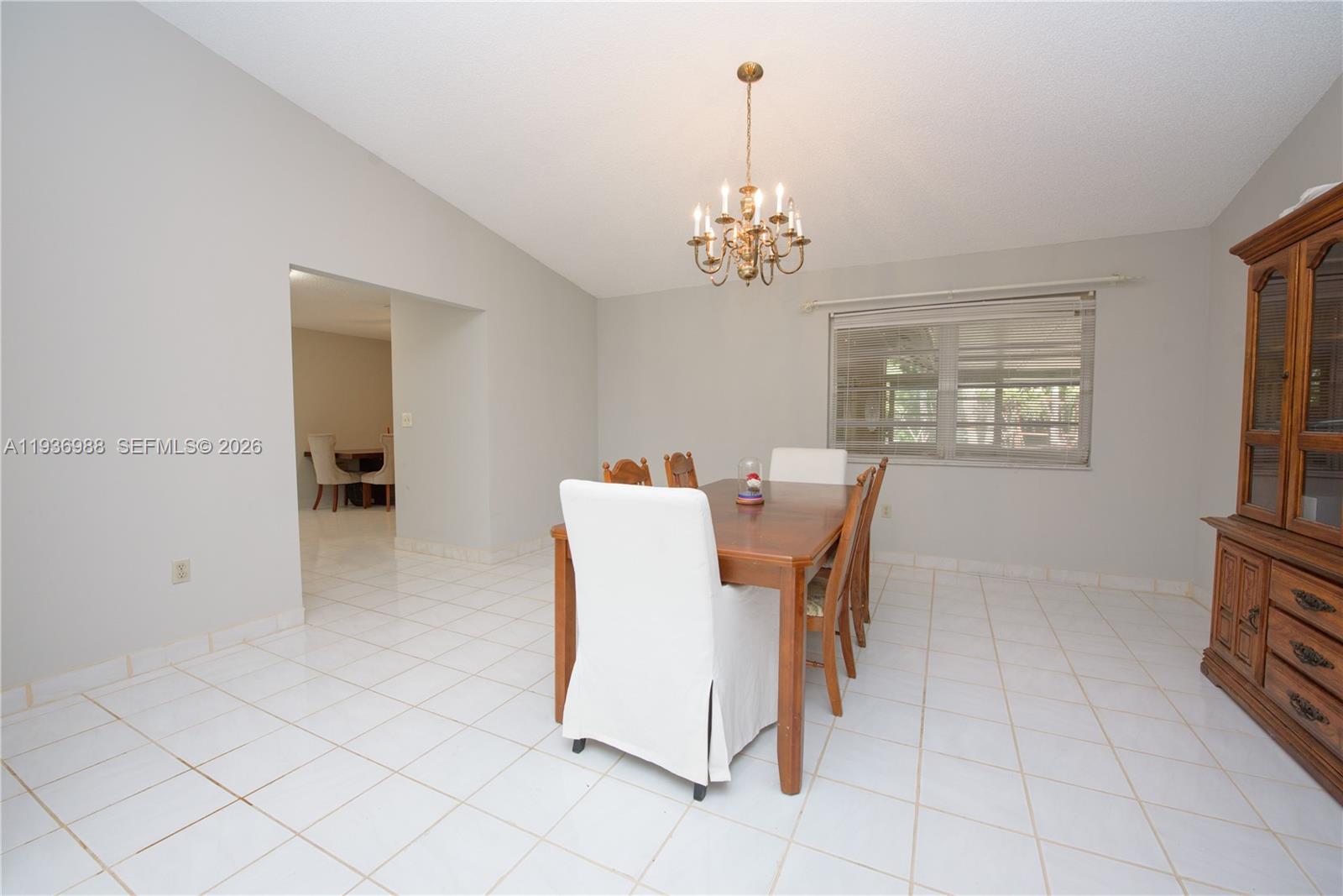 21295 Southwest 376th Street Homestead, FL 33034 - Photo 12 of 51 a view of a dining room with furniture and chandelier