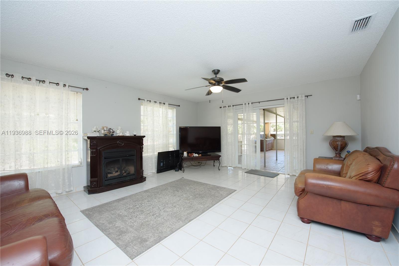 21295 Southwest 376th Street Homestead, FL 33034 - Photo 13 of 51 a living room with furniture and a flat screen tv