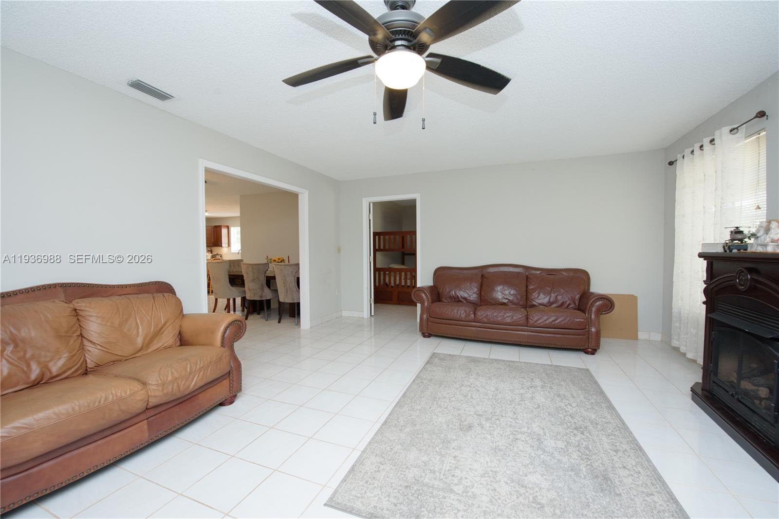 21295 Southwest 376th Street Homestead, FL 33034 - Photo 14 of 51 a living room with furniture and a couch