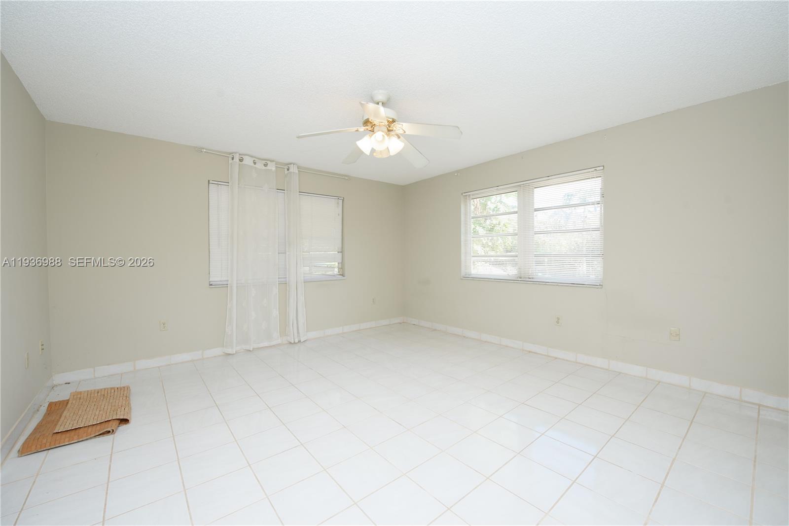 21295 Southwest 376th Street Homestead, FL 33034 - Photo 20 of 51 an empty room with windows and fan