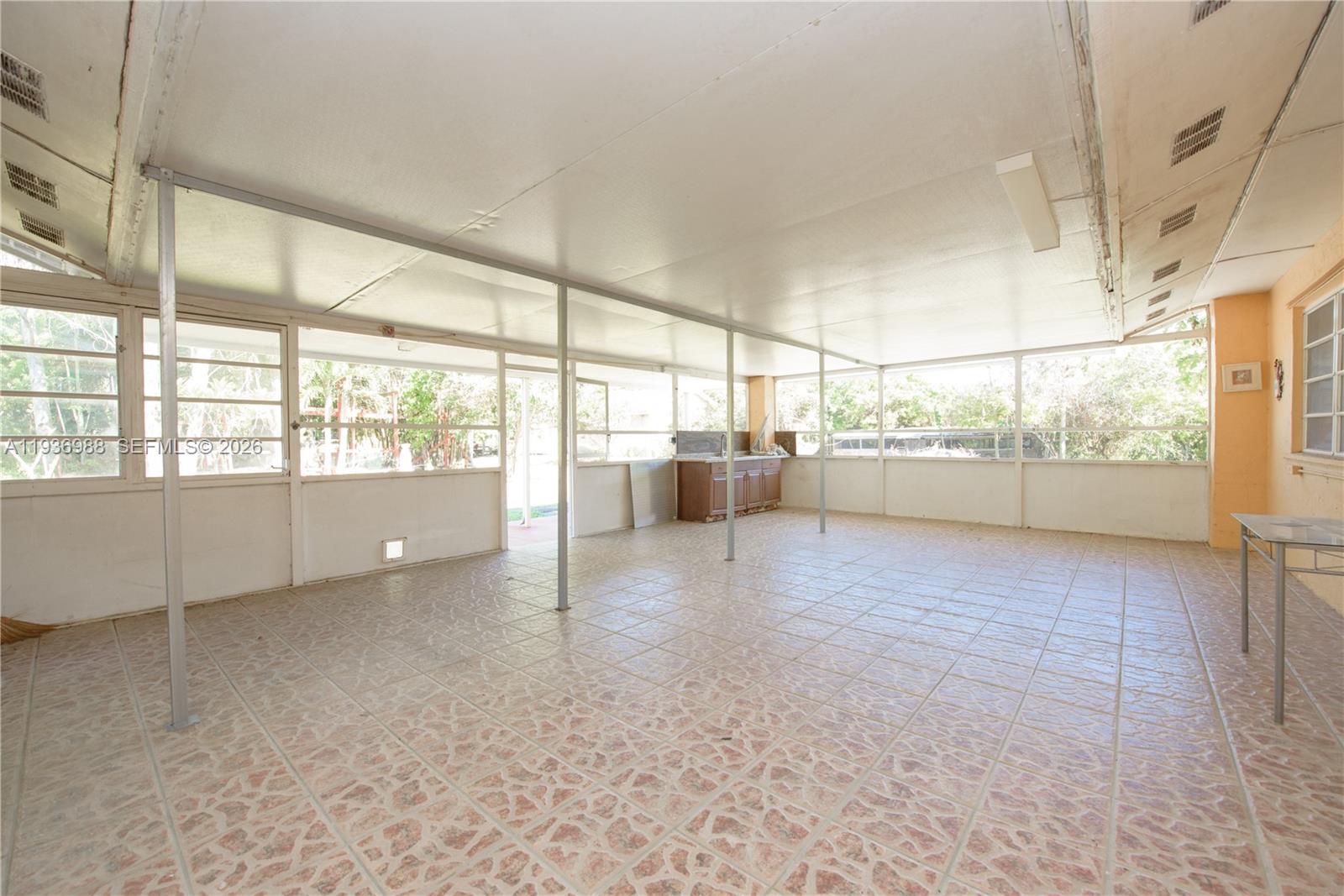21295 Southwest 376th Street Homestead, FL 33034 - Photo 25 of 51 a view of a big room with wooden floor and windows