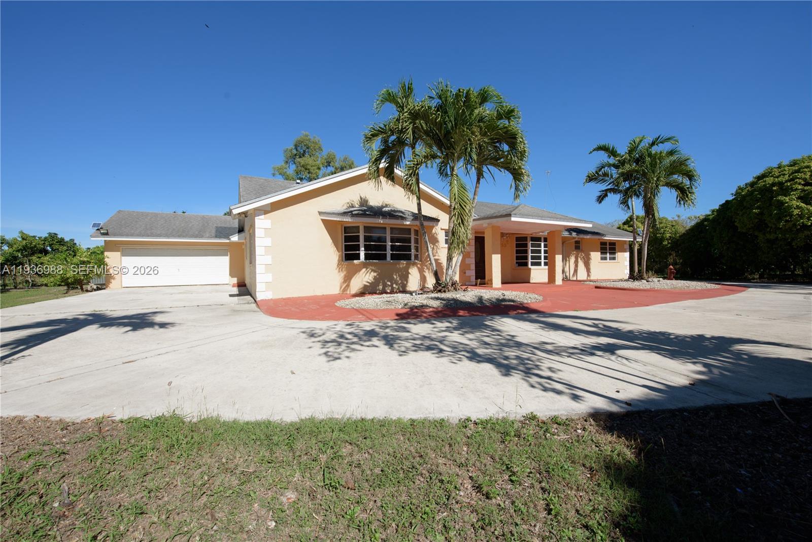 21295 Southwest 376th Street Homestead, FL 33034 - Photo 27 of 51 a front view of a house with a yard and garage
