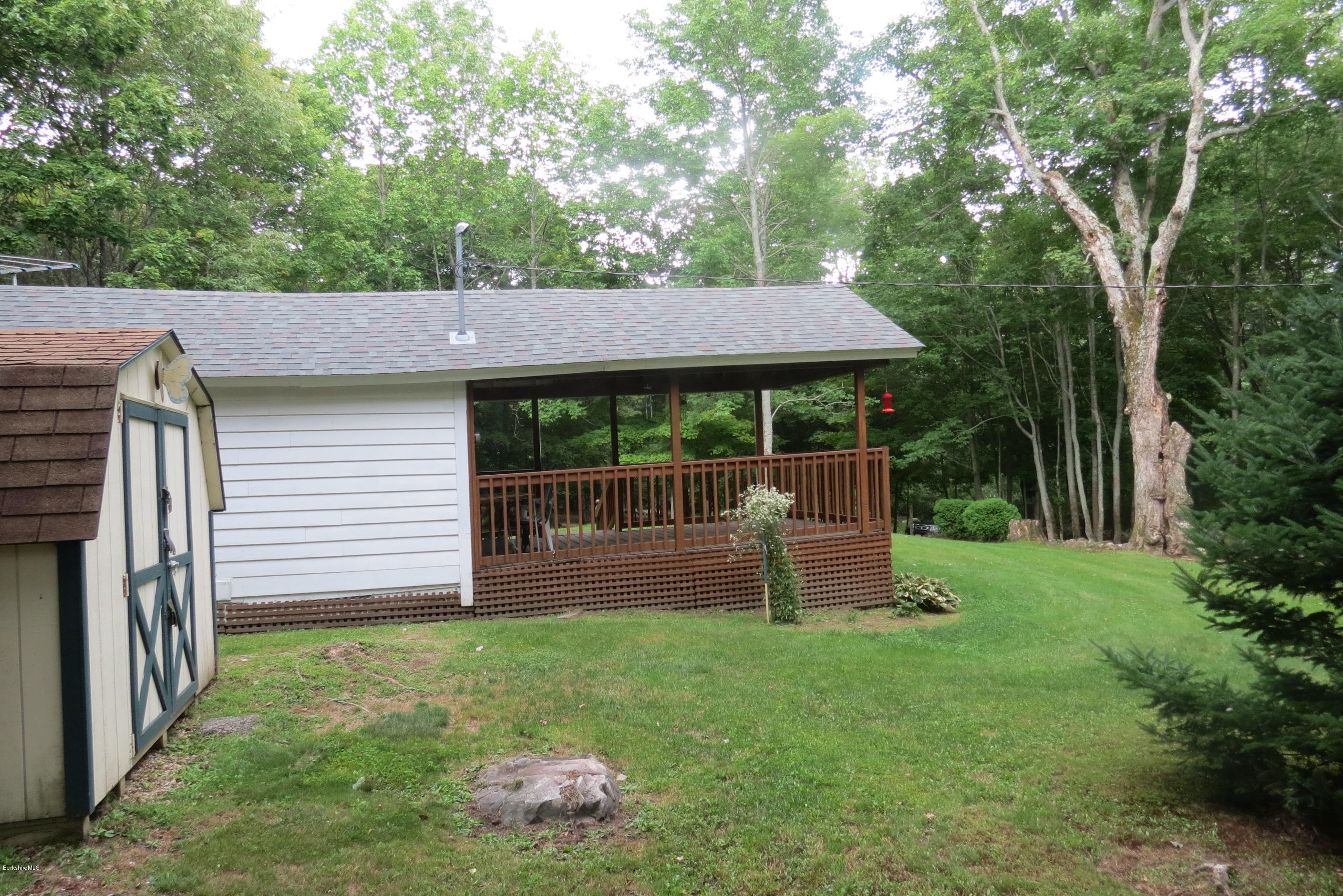 1818-2 County Road Stamford, VT 05352 - Photo 6 of 59 a front view of a house with a garden and swing