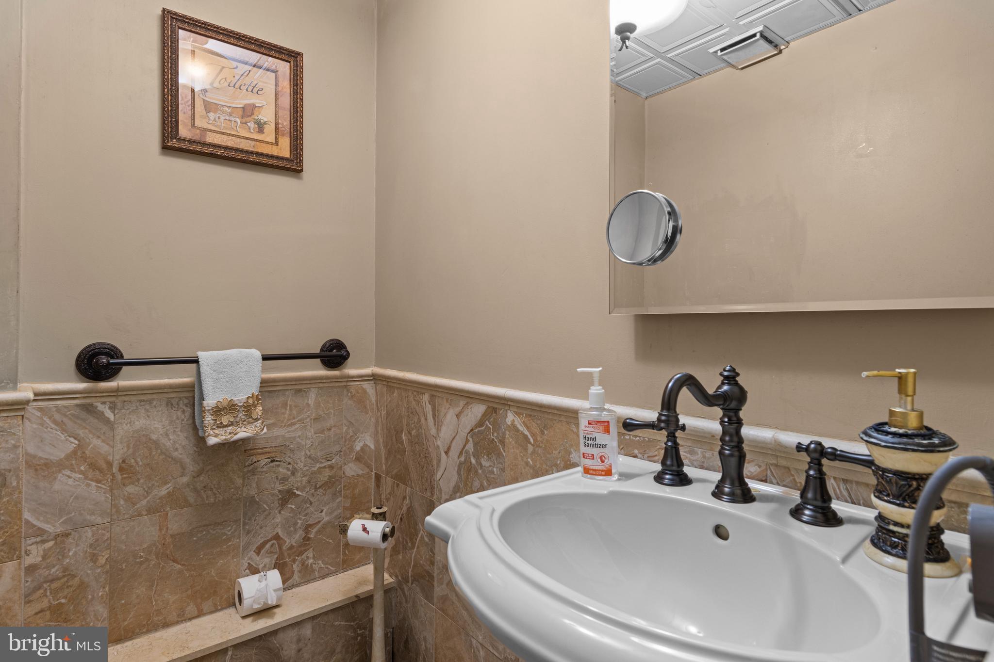 2606 Springfield Road Broomall, PA 19008 - Photo 22 of 32 a bathroom with a sink and a mirror