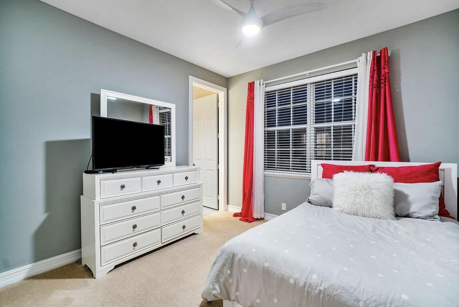 111 Southwest 2nd Avenue Delray Beach, FL 33444 - Photo 13 of 33 a bedroom with a bed and flat screen tv