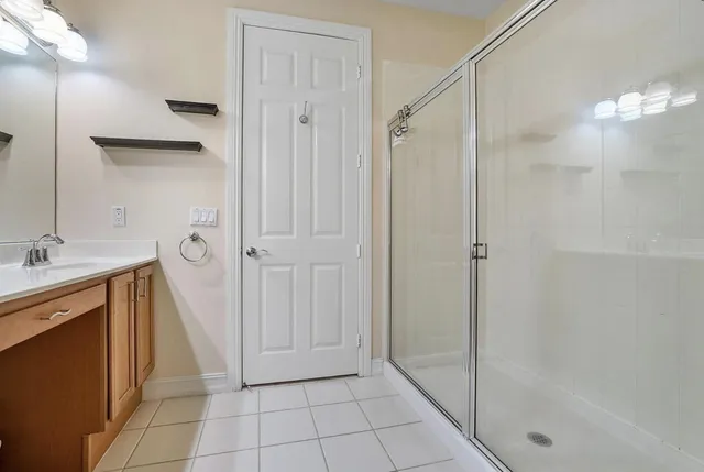 a bathroom with a shower and a sink