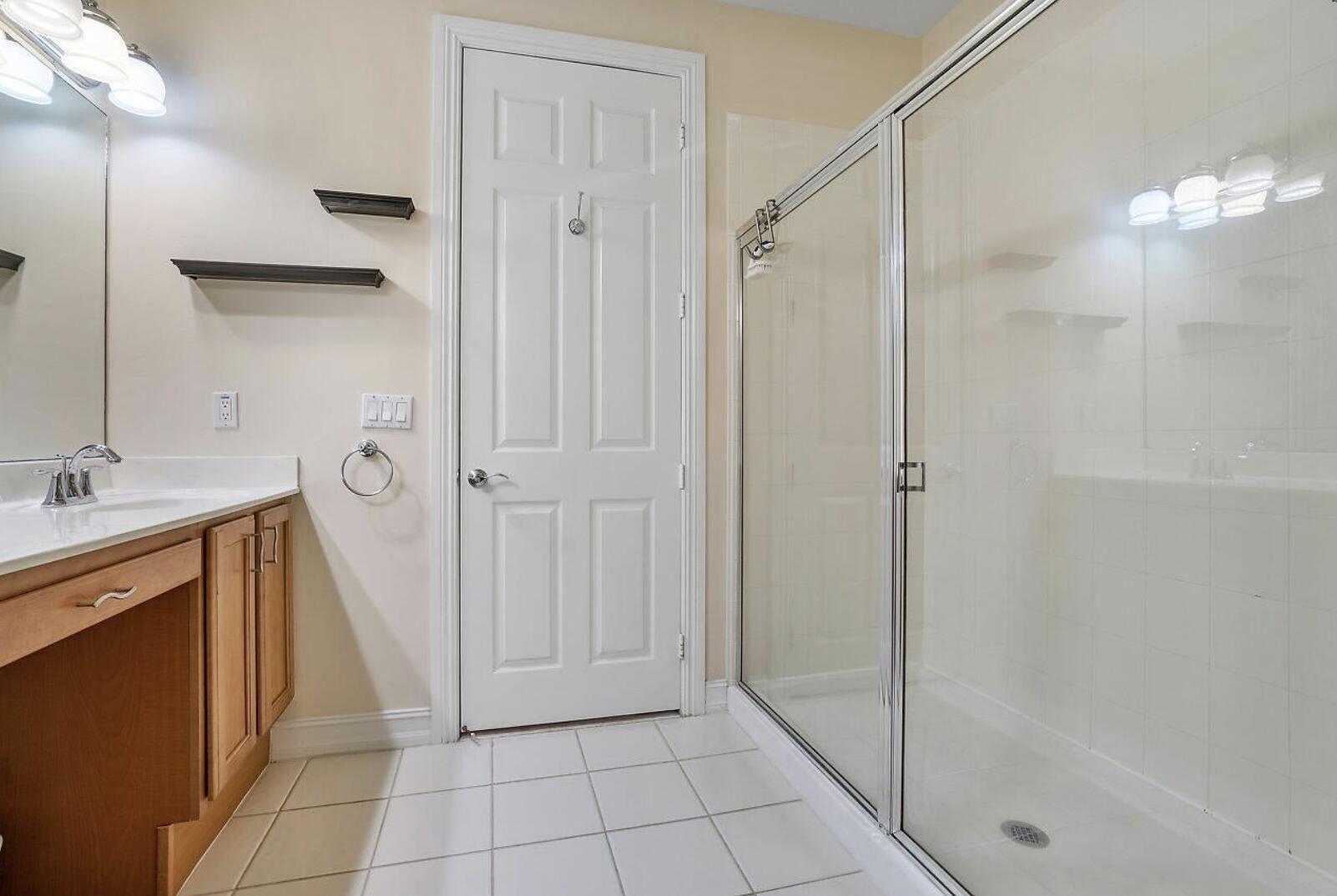 111 Southwest 2nd Avenue Delray Beach, FL 33444 - Photo 18 of 33 a bathroom with a shower and a sink