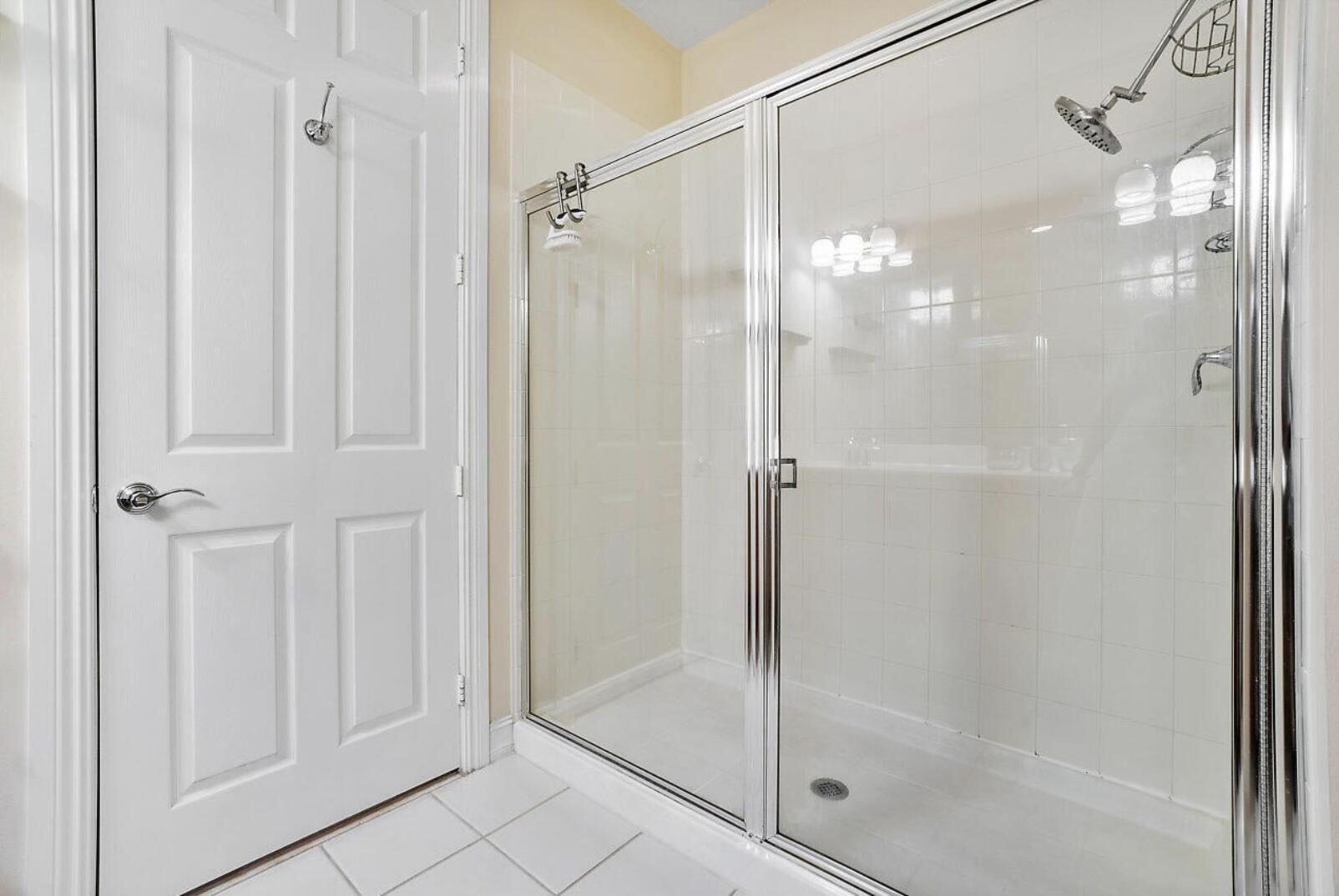 111 Southwest 2nd Avenue Delray Beach, FL 33444 - Photo 19 of 33 a bathroom with a glass shower door