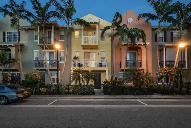 a couple of palm trees in front of a house