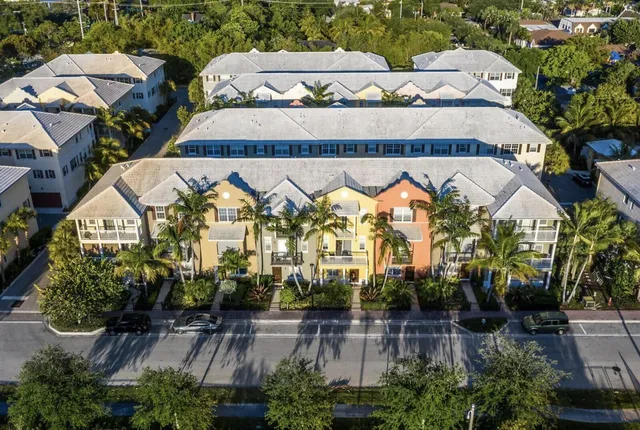 an aerial view of a building with garden space and swimming pool