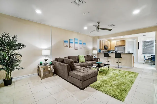 a living room with furniture and a chandelier