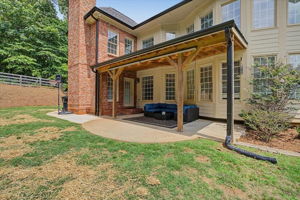122 Ridge View Drive Ball Ground, GA 30107 - Photo 75 of 84 a view of a house with backyard porch and sitting area