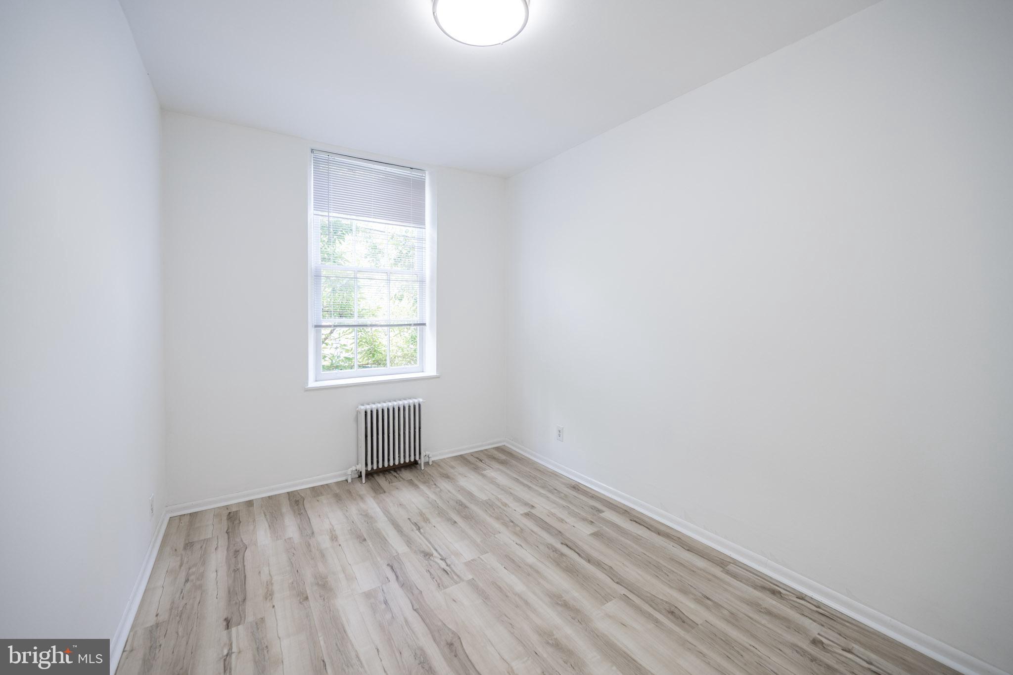 625 South 10th Street, Unit 2F Philadelphia, PA 19147 - Photo 6 of 13 an empty room with wooden floor and windows