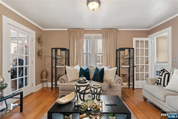 a living room with furniture a bookshelf and a large window