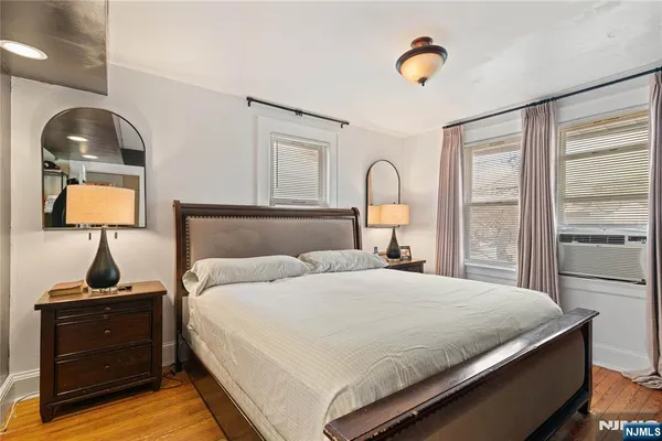 a bedroom with a bed and a lamp