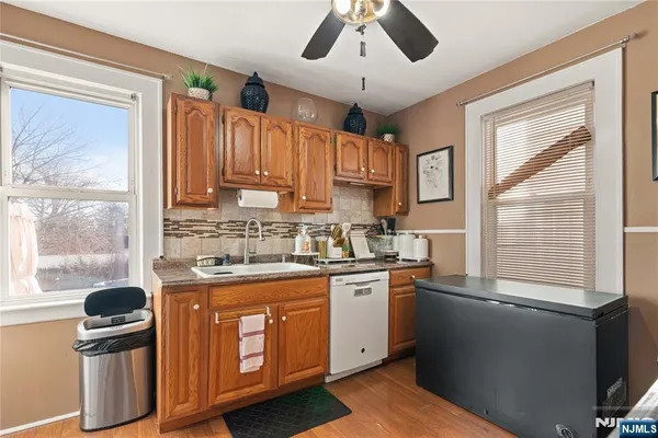 a kitchen with stainless steel appliances granite countertop a sink a stove and a refrigerator
