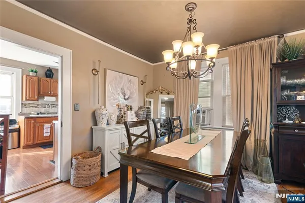 a view of a dining room with furniture and chandelier