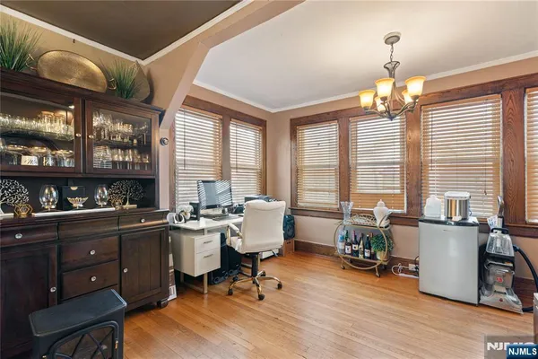 a view of a livingroom with workspace and windows