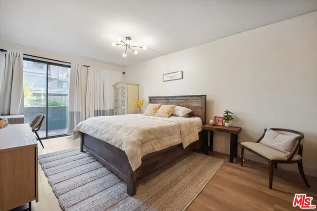 a bedroom with a large bed a lamp and a large window