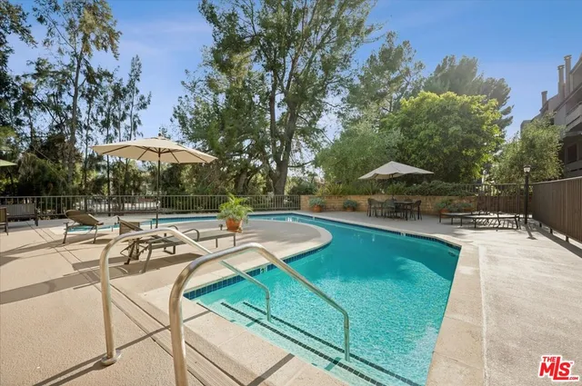 a view of a swimming pool with lounge chairs