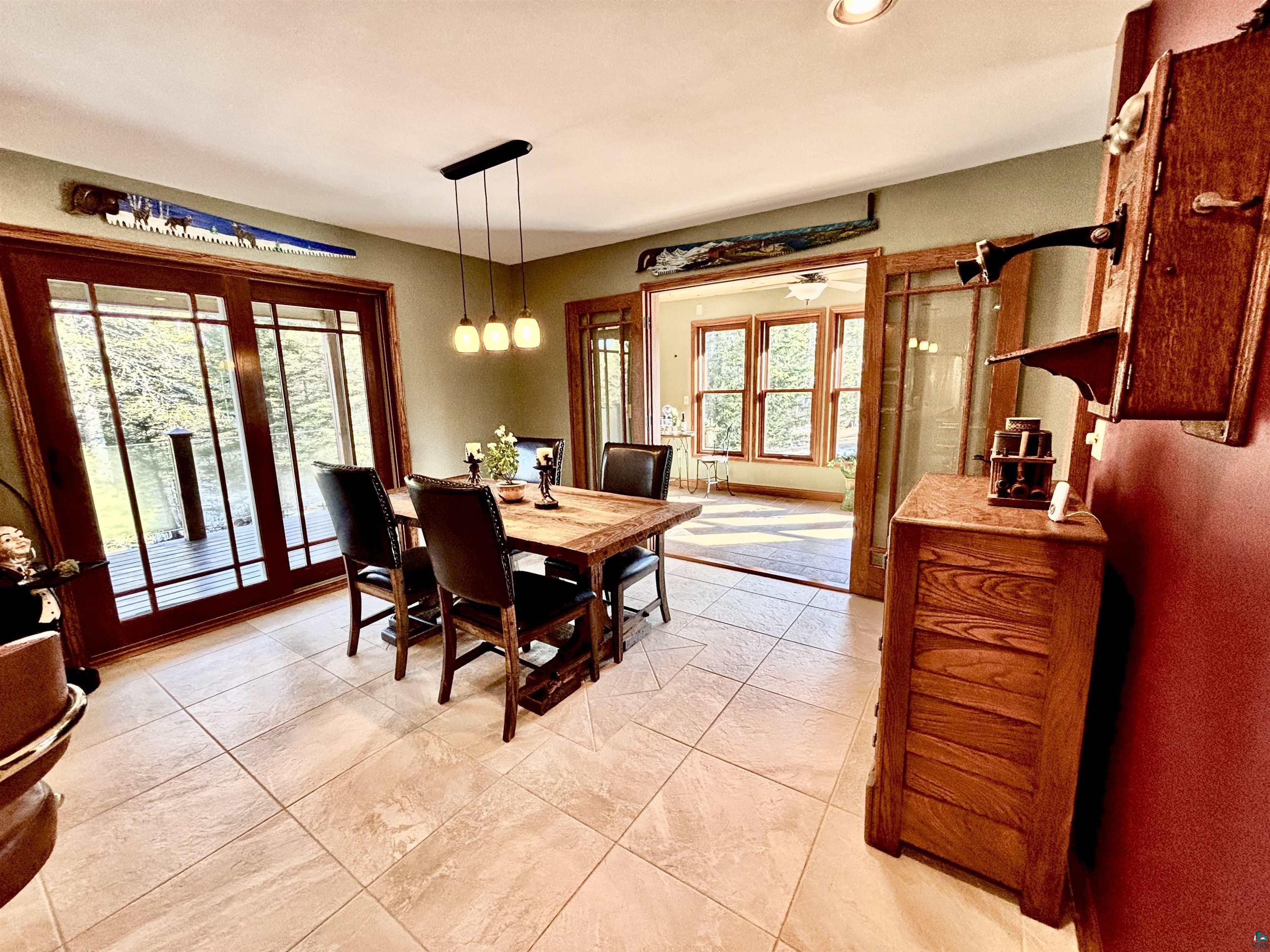 21 Turnagain Trail Lutsen, MN 55612 - Photo 12 of 77 Dining area featuring large wood-frame sliding glass doors opening to an exterior deck