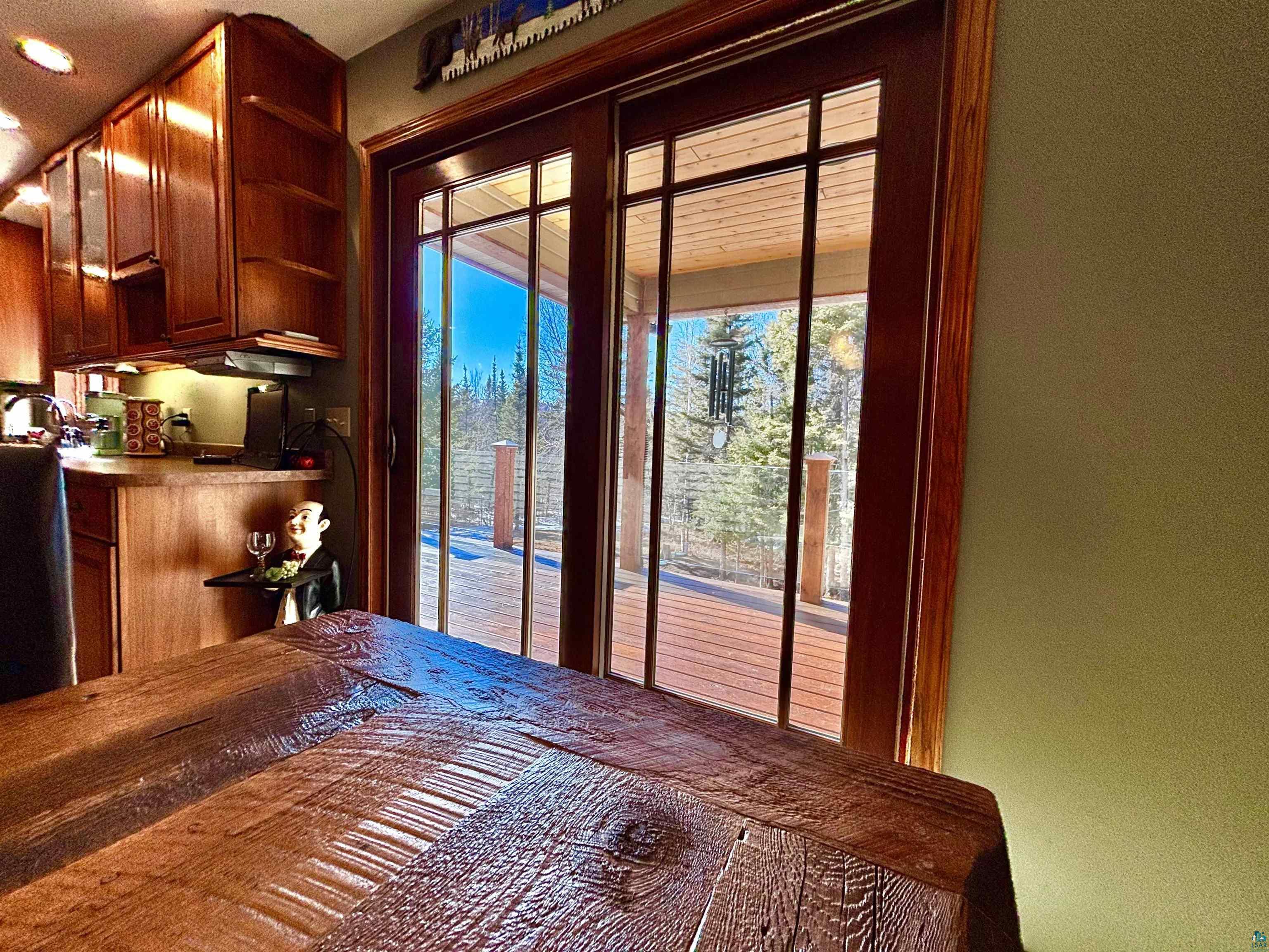 21 Turnagain Trail Lutsen, MN 55612 - Photo 17 of 77 Sliding glass patio doors with wood-finish frames, opening to an outdoor deck
