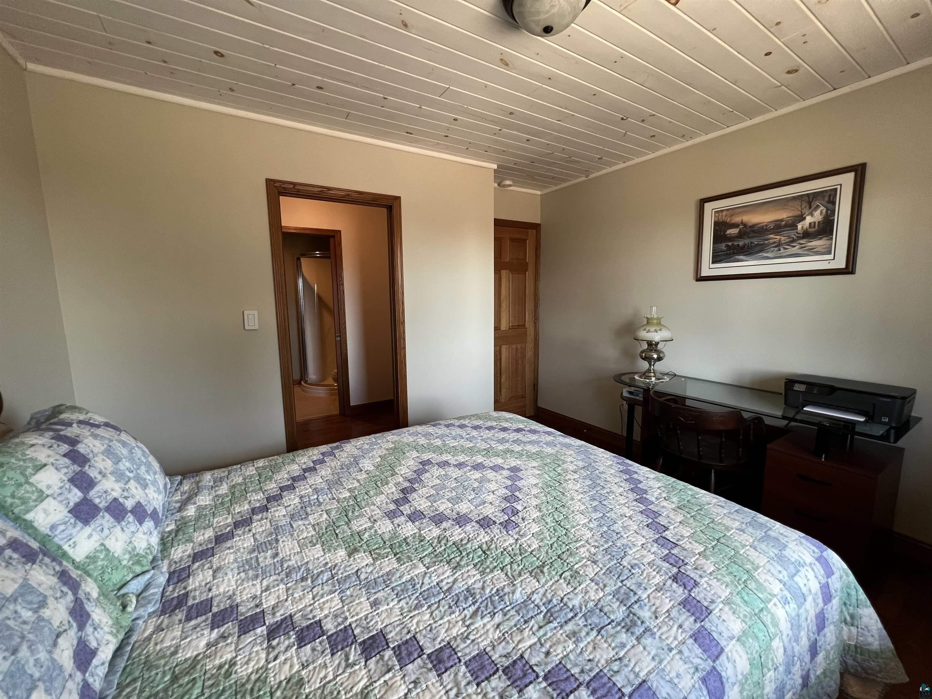 21 Turnagain Trail Lutsen, MN 55612 - Photo 25 of 77 Bedroom featuring a paneled wood ceiling and warm neutral wall tones