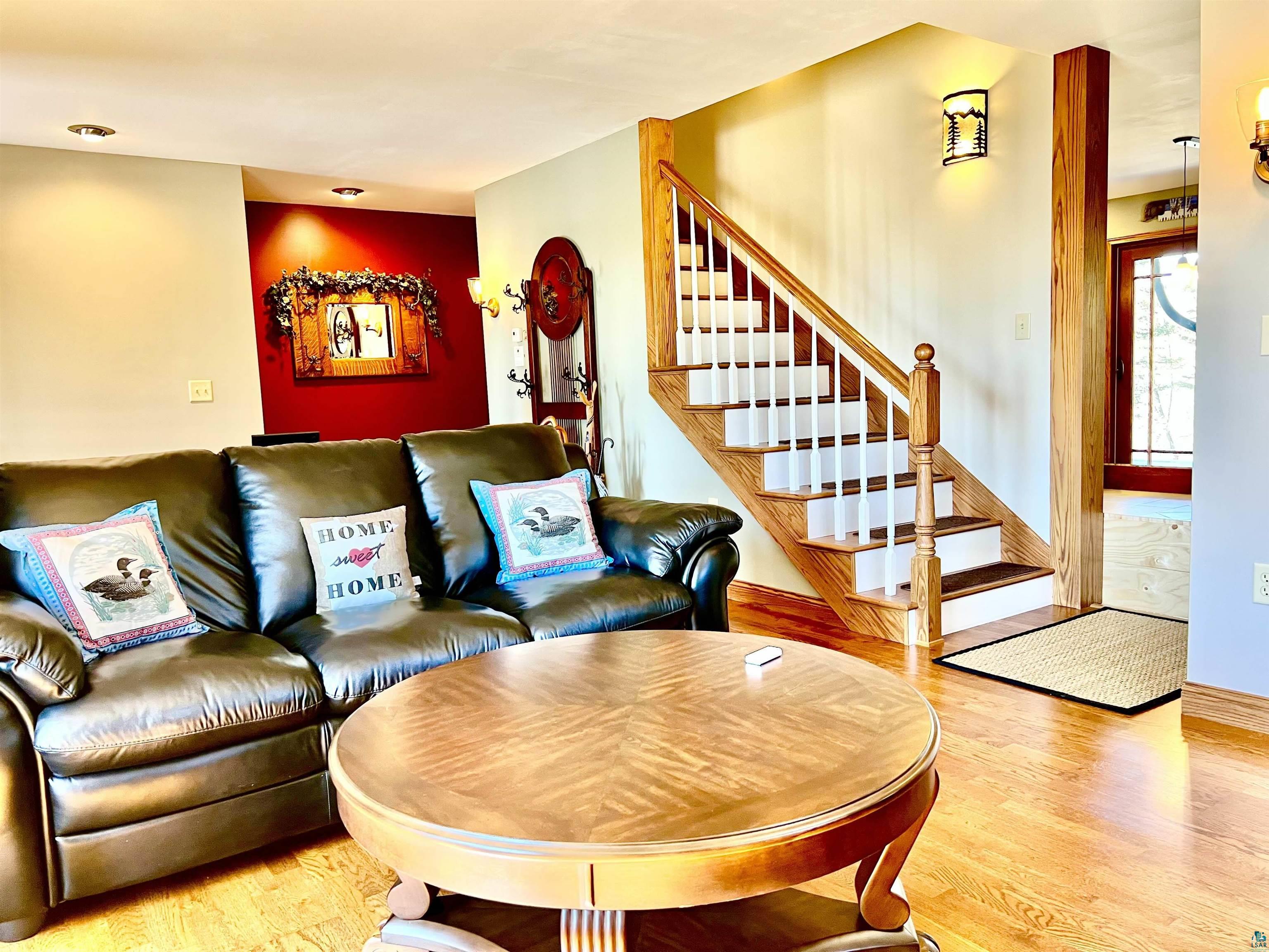 21 Turnagain Trail Lutsen, MN 55612 - Photo 30 of 77 Hardwood flooring and a wood staircase with white risers define this living area
