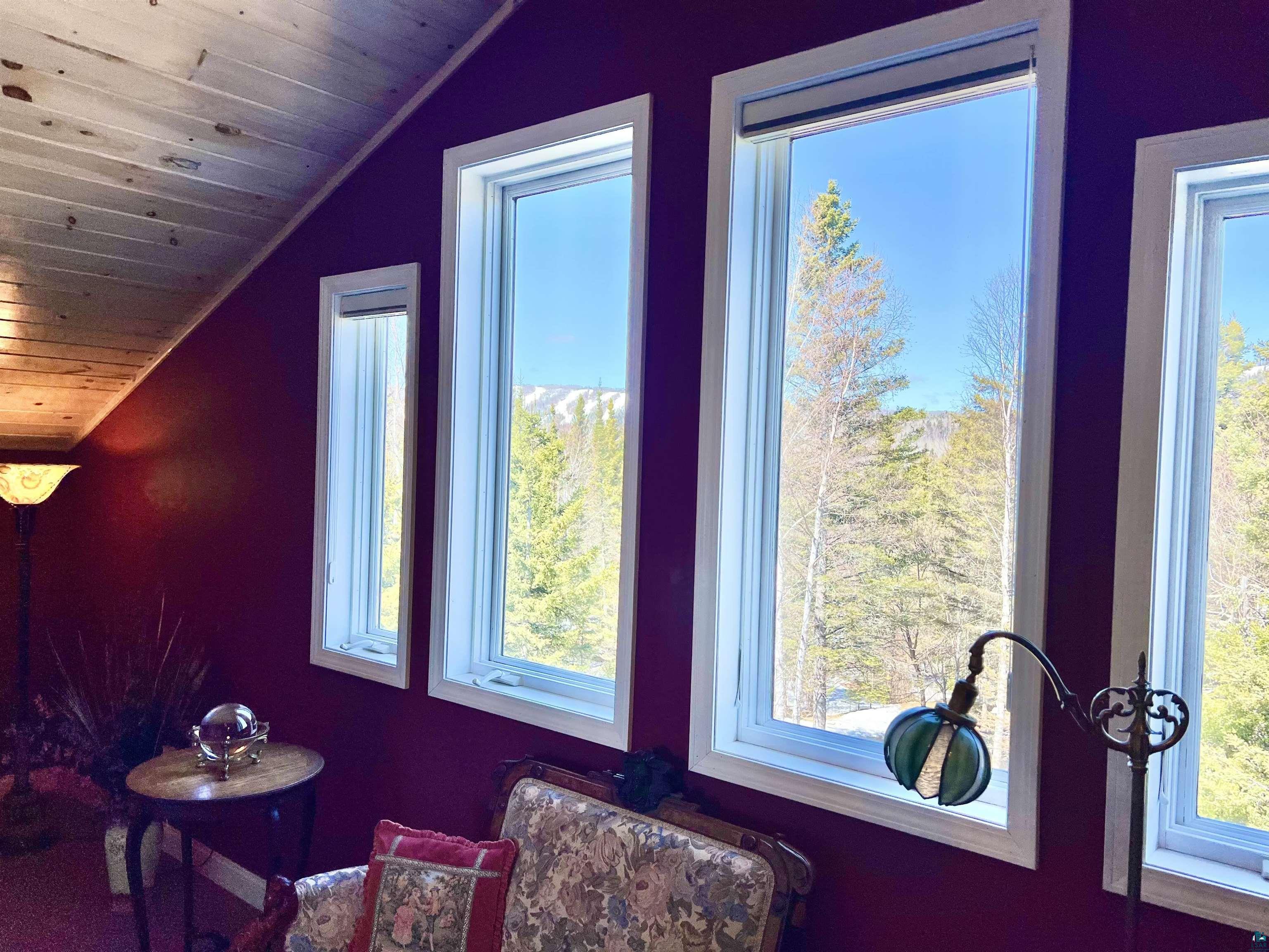 21 Turnagain Trail Lutsen, MN 55612 - Photo 39 of 77 Multiple windows with white trim framing expansive outdoor scenery