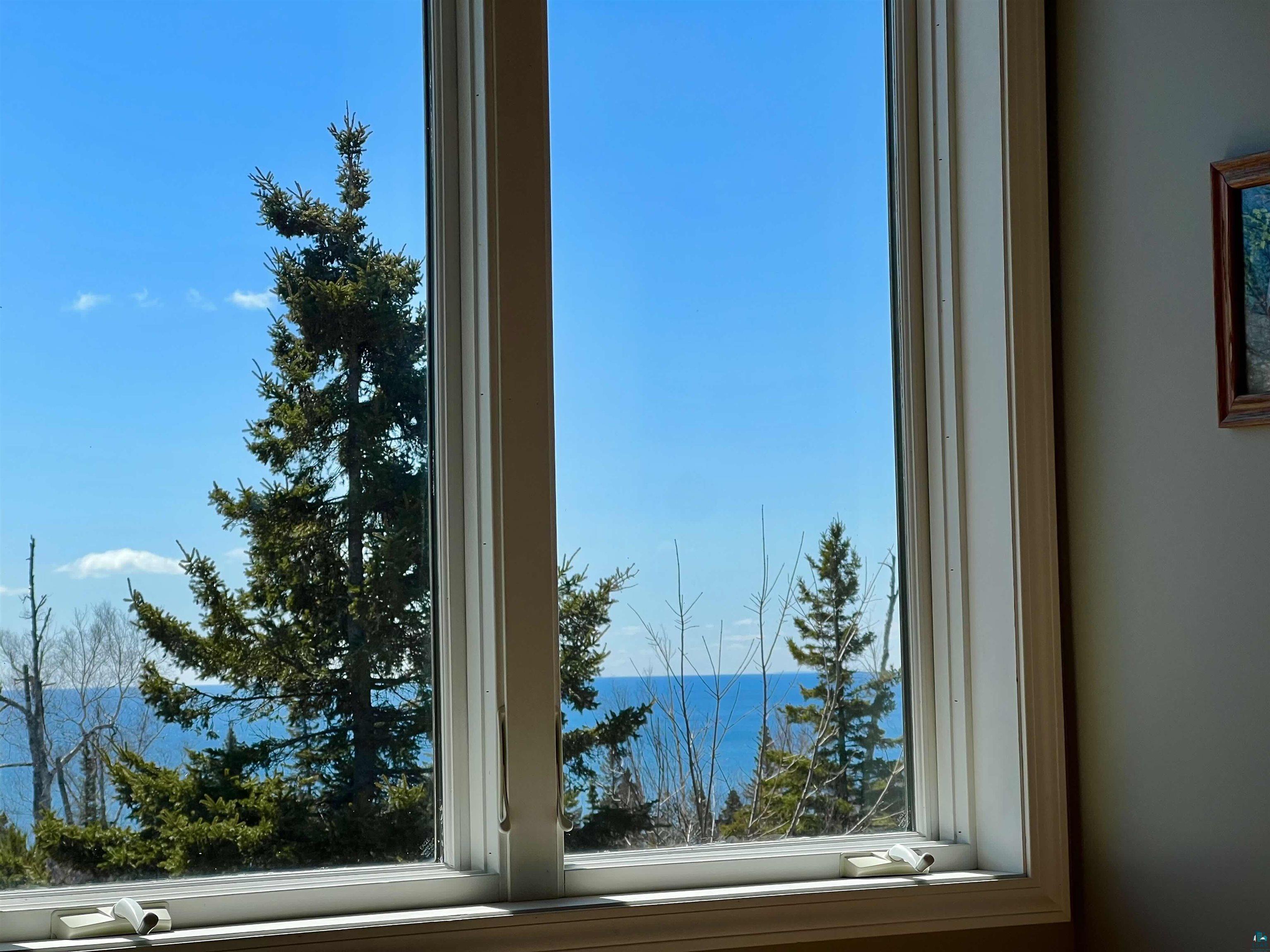 21 Turnagain Trail Lutsen, MN 55612 - Photo 4 of 77 Large window offering expansive views of a water body and surrounding trees