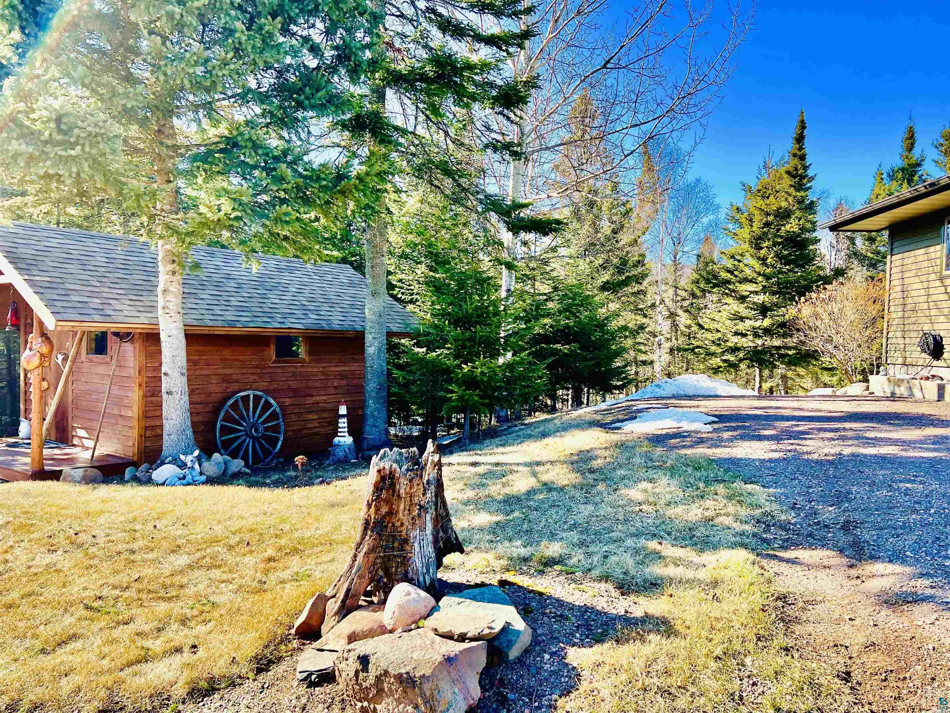 21 Turnagain Trail Lutsen, MN 55612 - Photo 46 of 77 Wood-sided auxiliary building with a shingled roof, set among mature evergreen trees