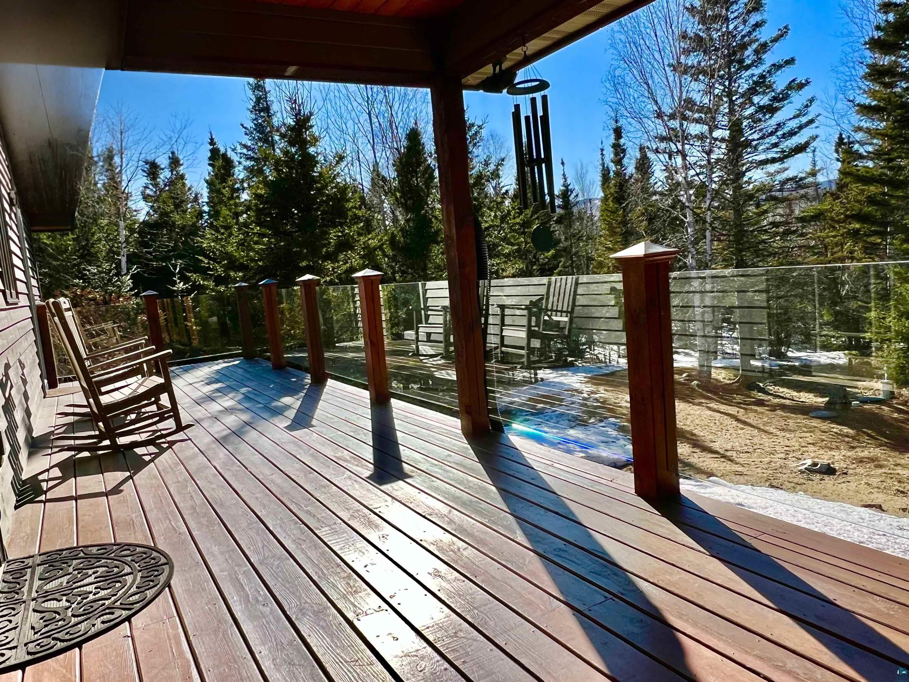 21 Turnagain Trail Lutsen, MN 55612 - Photo 49 of 77 Spacious wood-finish deck with a glass panel railing and wood posts